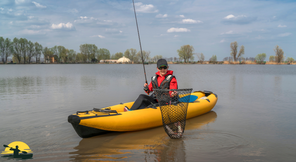 A lady is fishing on a kayak