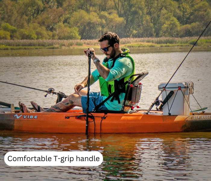 A man is inserting the kayak stake-out pole into the water