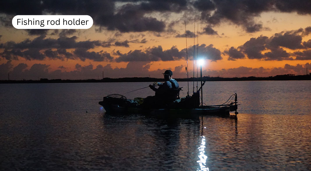 A man is kayaking at night