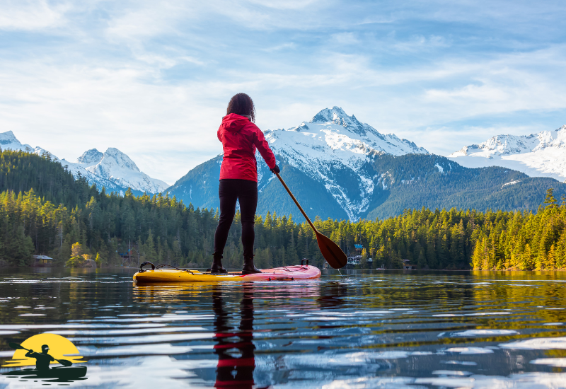 A woman is paddling a board