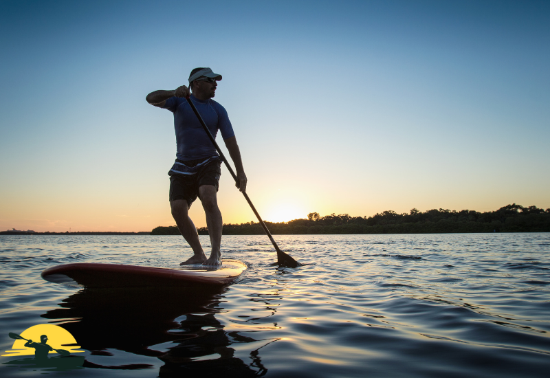 A man is paddling a board