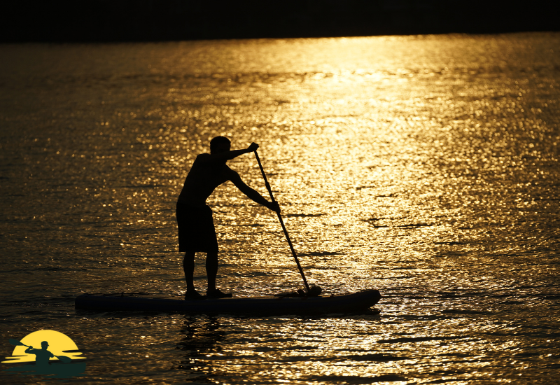 A man is paddling a board