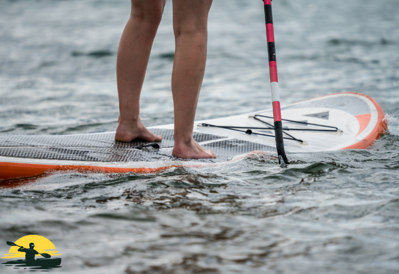 A man is paddling a board