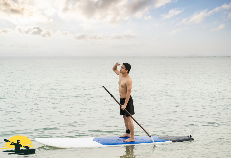 A man Standing on a Paddle Board