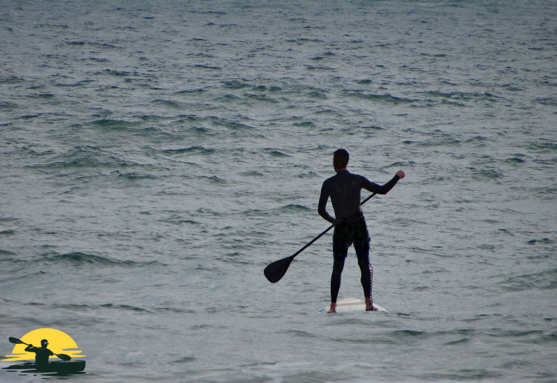 A man Standing on a Paddle Board