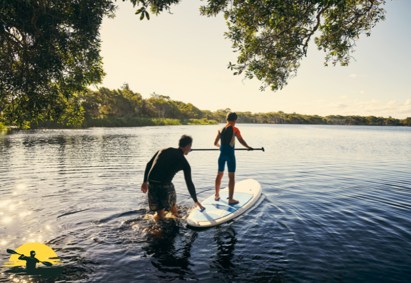 A man is paddling a  board