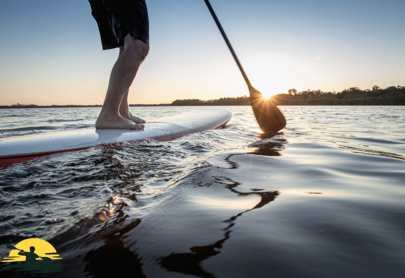 A man is paddling a board